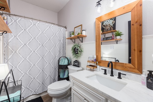 bathroom featuring tile walls, wood-type flooring, a shower with curtain, vanity, and toilet