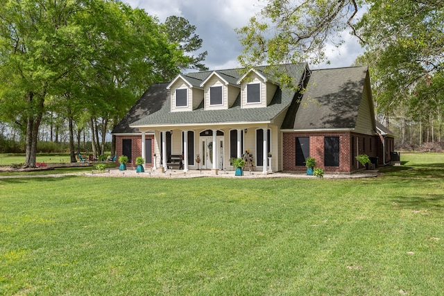 rear view of property featuring a lawn and covered porch