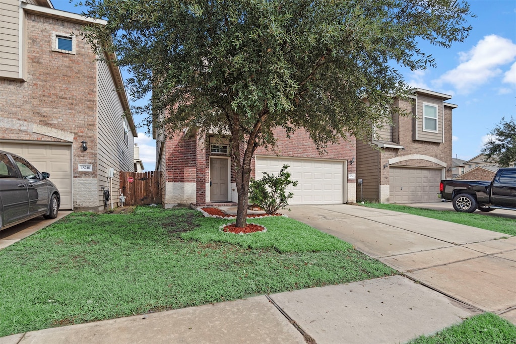 view of front of home with a garage and a front yard