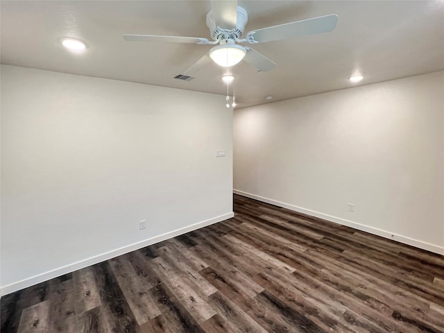 empty room with dark hardwood / wood-style flooring and ceiling fan