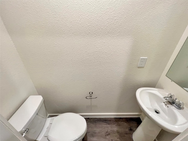 bathroom featuring toilet and sink