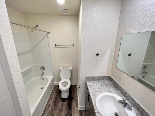 full bathroom with wood-type flooring, vanity, toilet, and bathtub / shower combination