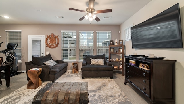 living room featuring light hardwood / wood-style floors and ceiling fan