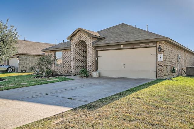 ranch-style home featuring a garage, a front yard, and central AC