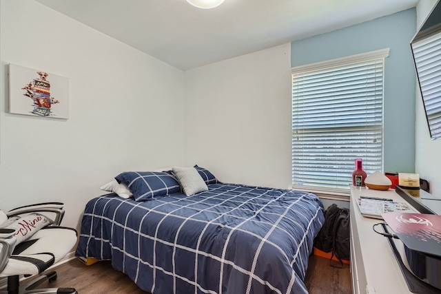 bedroom with hardwood / wood-style flooring