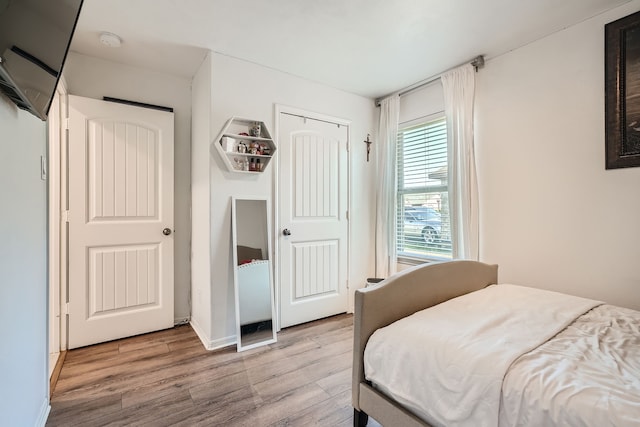 bedroom with a closet and light wood-type flooring