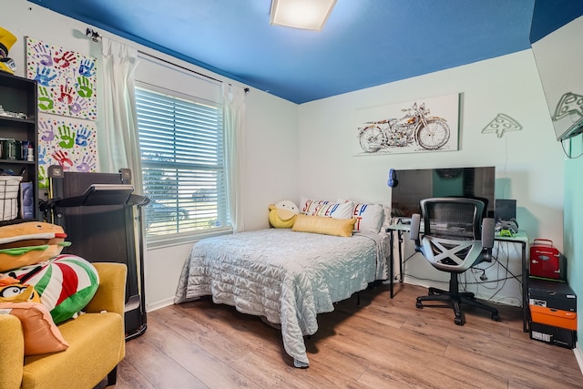 bedroom with hardwood / wood-style flooring