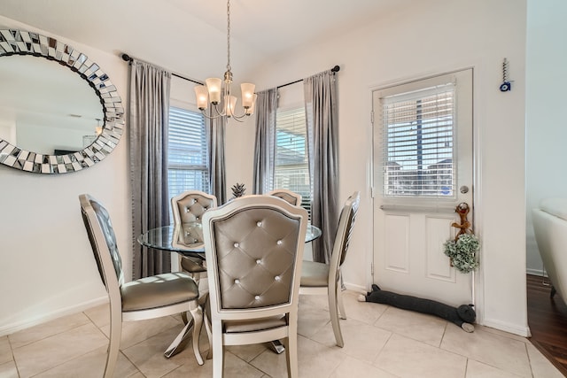 tiled dining space with a chandelier