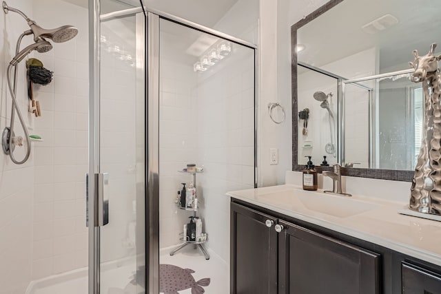 bathroom with walk in shower and vanity