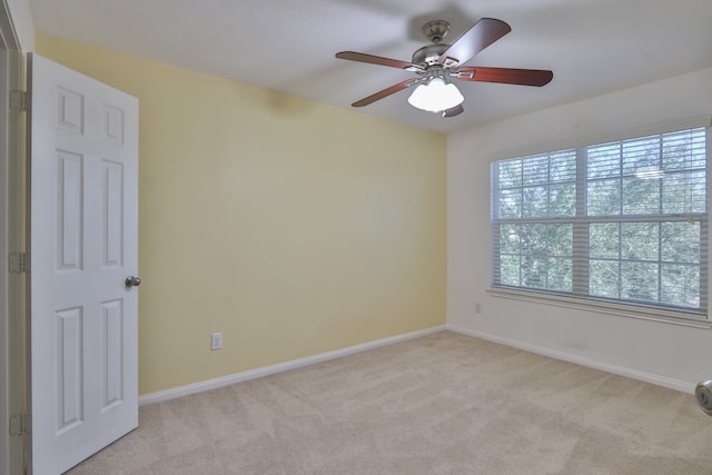 carpeted empty room featuring ceiling fan