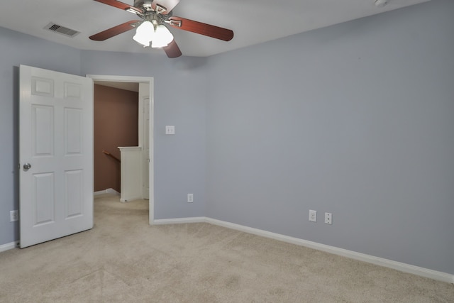 unfurnished room featuring ceiling fan and light carpet