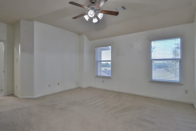 unfurnished room featuring plenty of natural light, light carpet, and ceiling fan