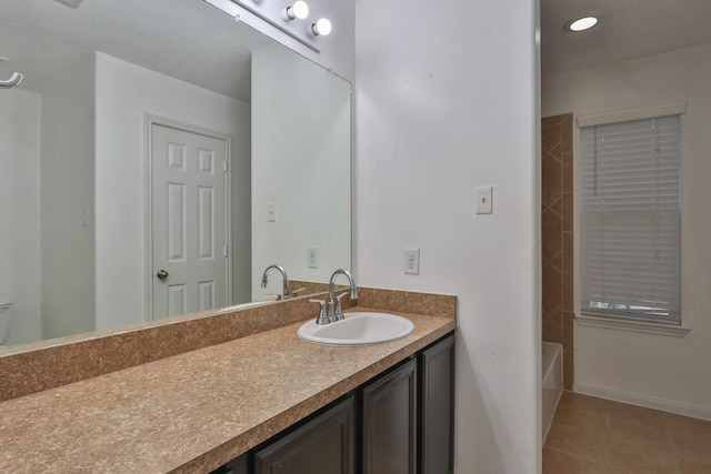 full bathroom featuring tile patterned floors, vanity, and baseboards