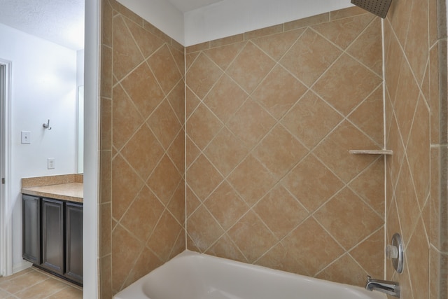 bathroom featuring vanity, tile patterned floors, and tiled shower / bath combo