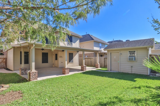 rear view of house with a lawn, ceiling fan, and a patio area