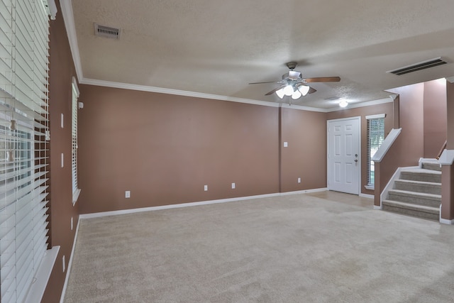 unfurnished living room with ceiling fan, light colored carpet, and crown molding