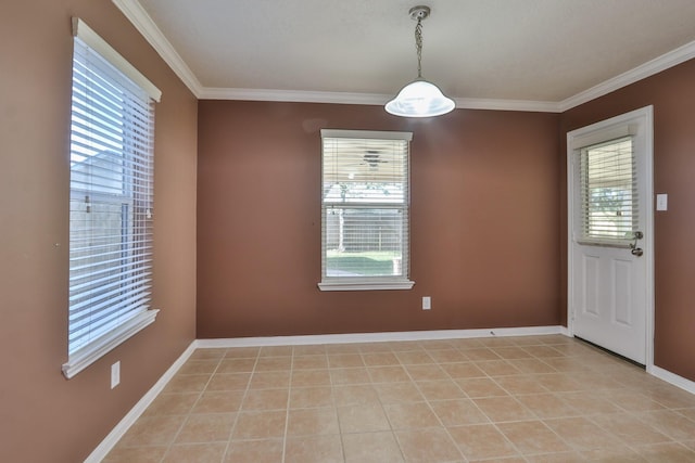 unfurnished room with light tile patterned floors, baseboards, a healthy amount of sunlight, and ornamental molding