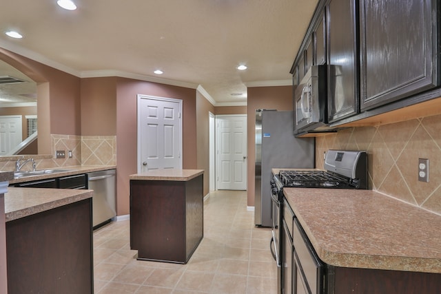 kitchen with a kitchen island, appliances with stainless steel finishes, light tile patterned floors, decorative backsplash, and sink