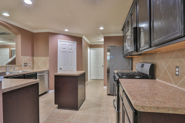 kitchen featuring a sink, a center island, stainless steel appliances, arched walkways, and crown molding