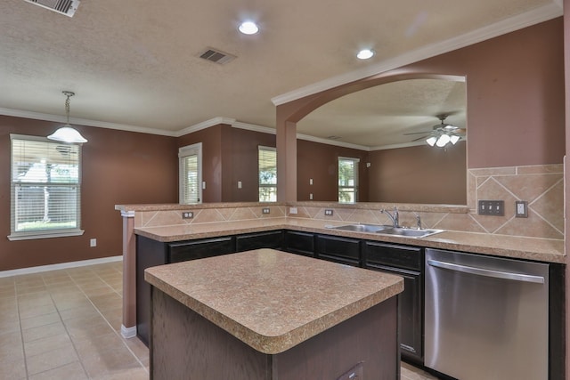 kitchen featuring visible vents, crown molding, dishwasher, decorative backsplash, and a sink