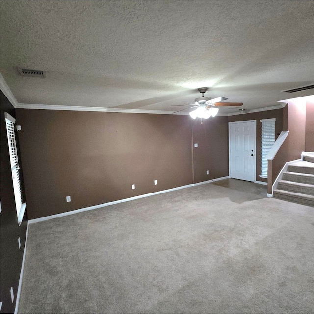 unfurnished living room featuring visible vents, baseboards, ceiling fan, and carpet flooring