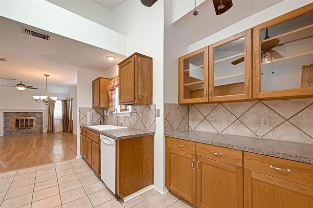 kitchen with sink, light tile patterned floors, an inviting chandelier, hanging light fixtures, and dishwasher