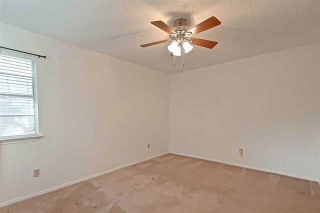 empty room with light carpet and ceiling fan