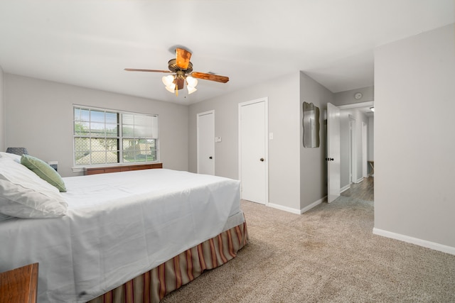 bedroom with ceiling fan and light colored carpet