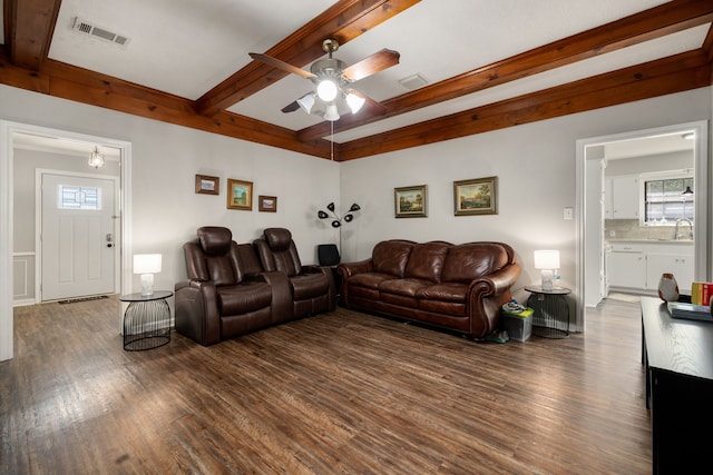 living room featuring ceiling fan, beam ceiling, dark hardwood / wood-style flooring, and sink