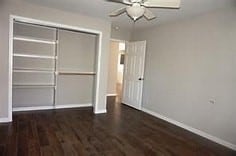 unfurnished bedroom featuring a closet, ceiling fan, and dark hardwood / wood-style floors