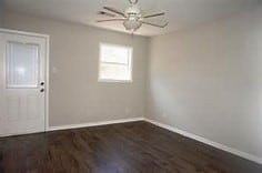 unfurnished room featuring dark hardwood / wood-style floors and ceiling fan