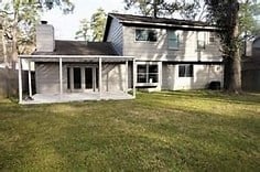 back of house with a patio area and a yard