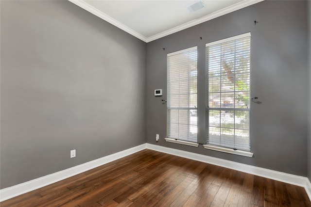 empty room featuring ornamental molding and hardwood / wood-style flooring