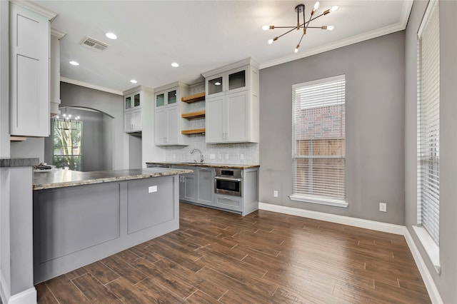 kitchen featuring ornamental molding, stainless steel oven, and dark hardwood / wood-style floors