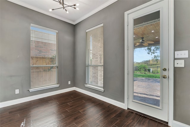 doorway to outside featuring a chandelier, dark hardwood / wood-style floors, and crown molding