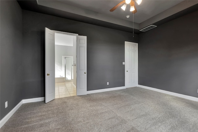 carpeted empty room featuring ceiling fan