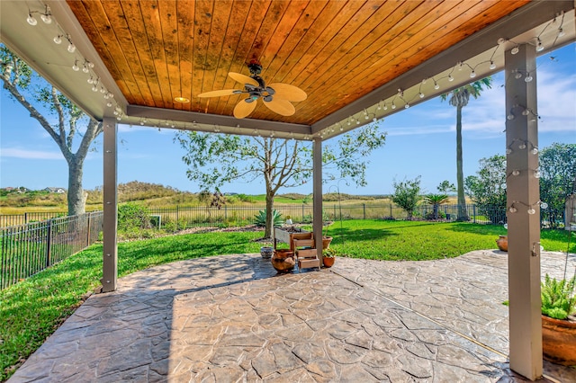 view of patio with ceiling fan and a rural view