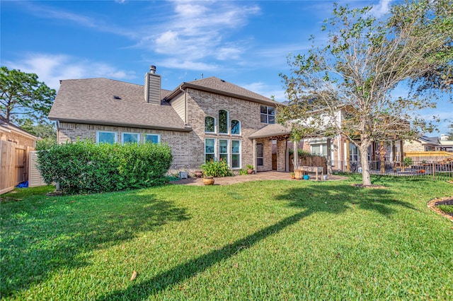 rear view of house with a lawn