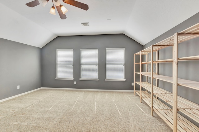 interior space with plenty of natural light, ceiling fan, and vaulted ceiling