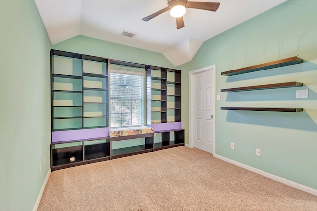 interior space featuring ceiling fan, carpet flooring, and lofted ceiling