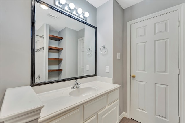 bathroom featuring vanity and hardwood / wood-style flooring