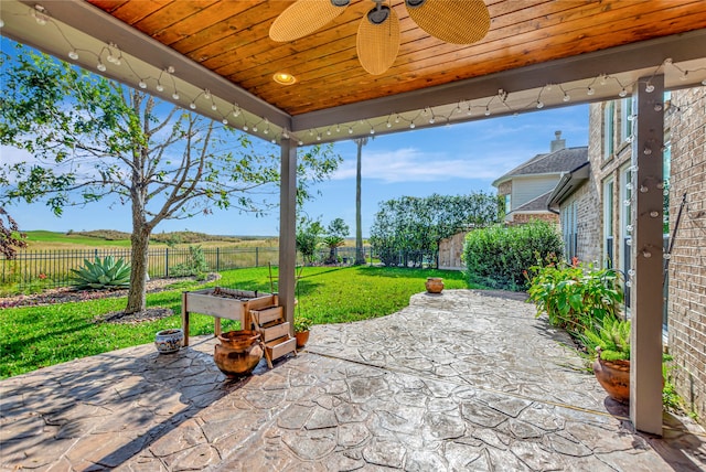 view of patio / terrace with ceiling fan and a rural view