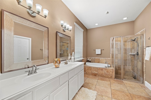 bathroom featuring tile patterned floors, vanity, and shower with separate bathtub