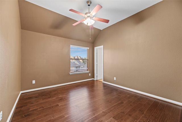 empty room featuring ceiling fan, dark hardwood / wood-style floors, and vaulted ceiling