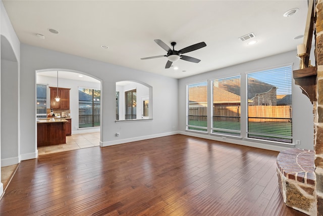 unfurnished living room with light hardwood / wood-style flooring and ceiling fan