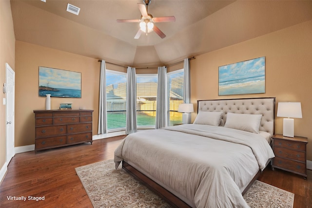 bedroom with ceiling fan, dark wood-type flooring, and lofted ceiling