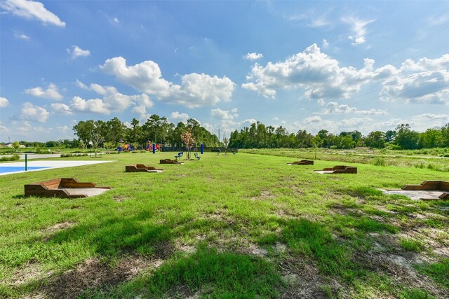 view of community featuring a lawn and a playground