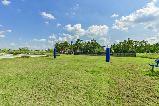 view of community with a yard and volleyball court