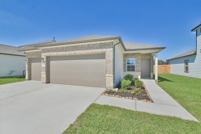 ranch-style house featuring a garage and a front lawn