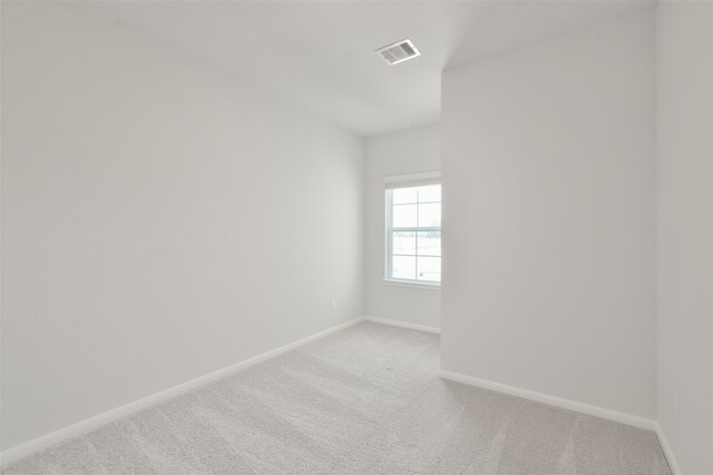 unfurnished room featuring light colored carpet